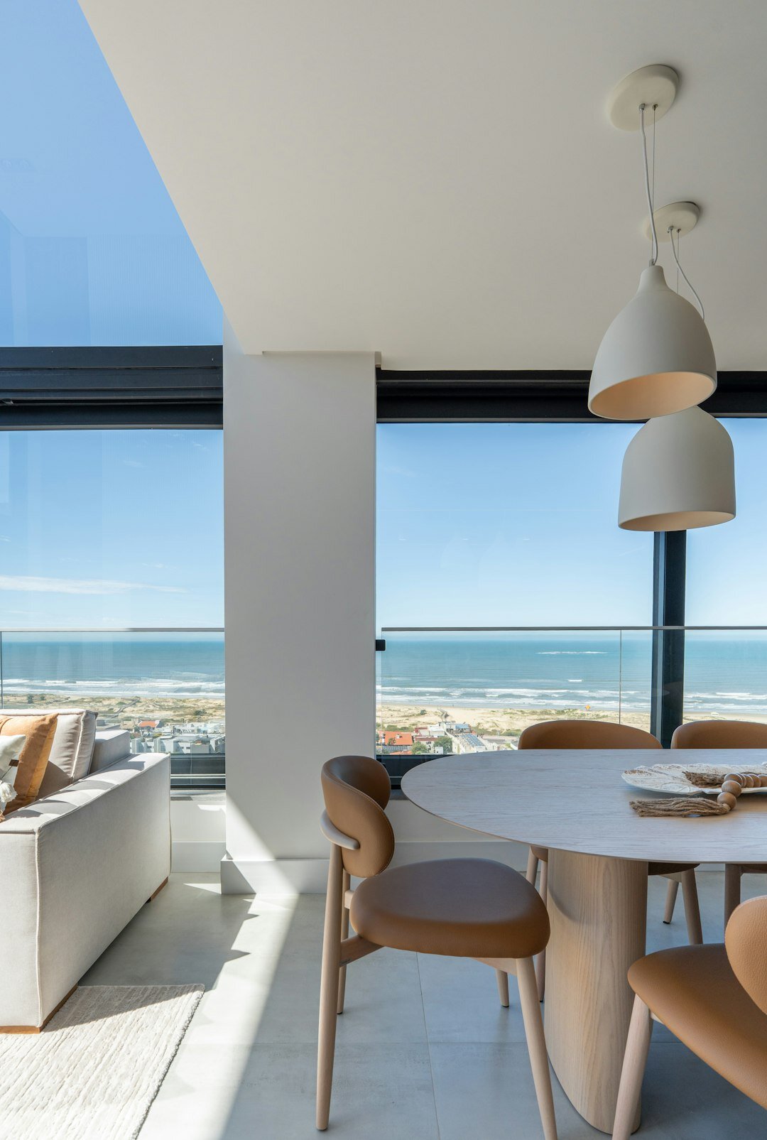 Minimalist living room interior with ocean view and linen furniture