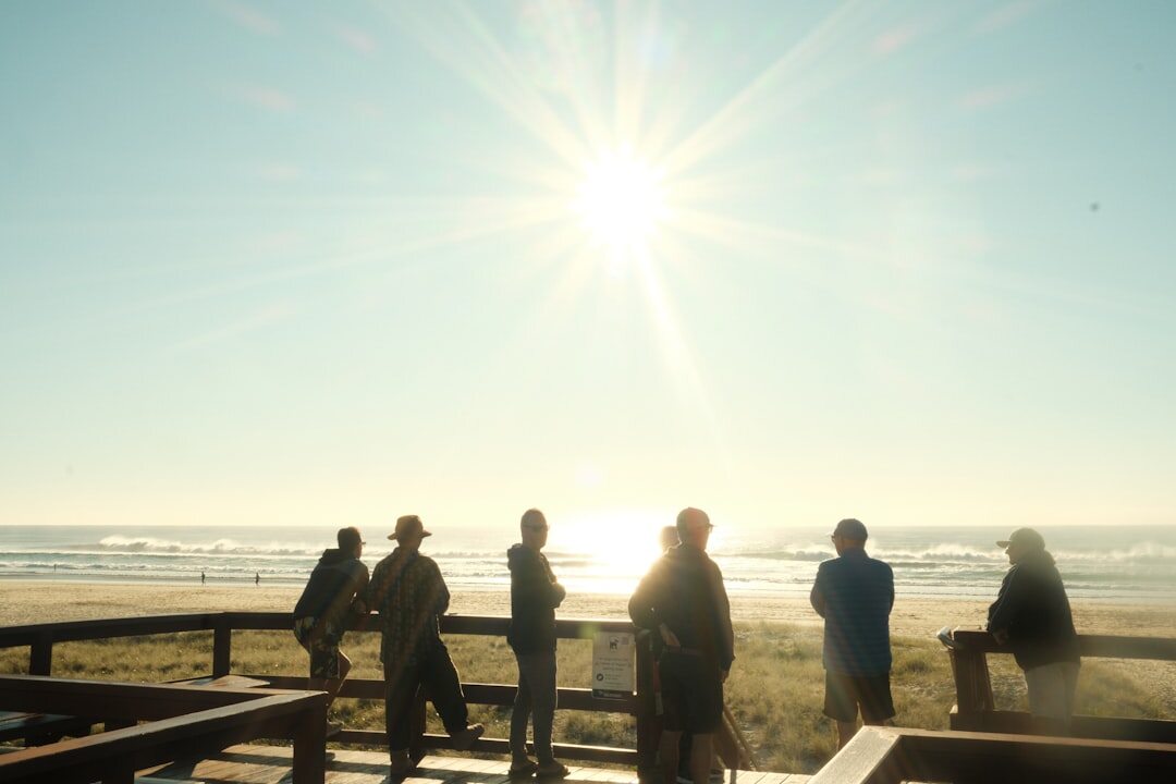 Team of real estate professionals meeting outdoors near the coast